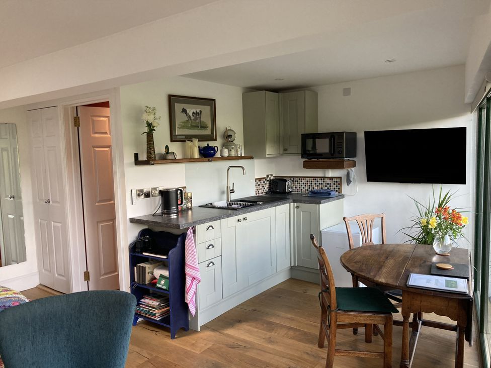 A kitchen with a table and chairs at The Sett on the Wharfe in Skipton