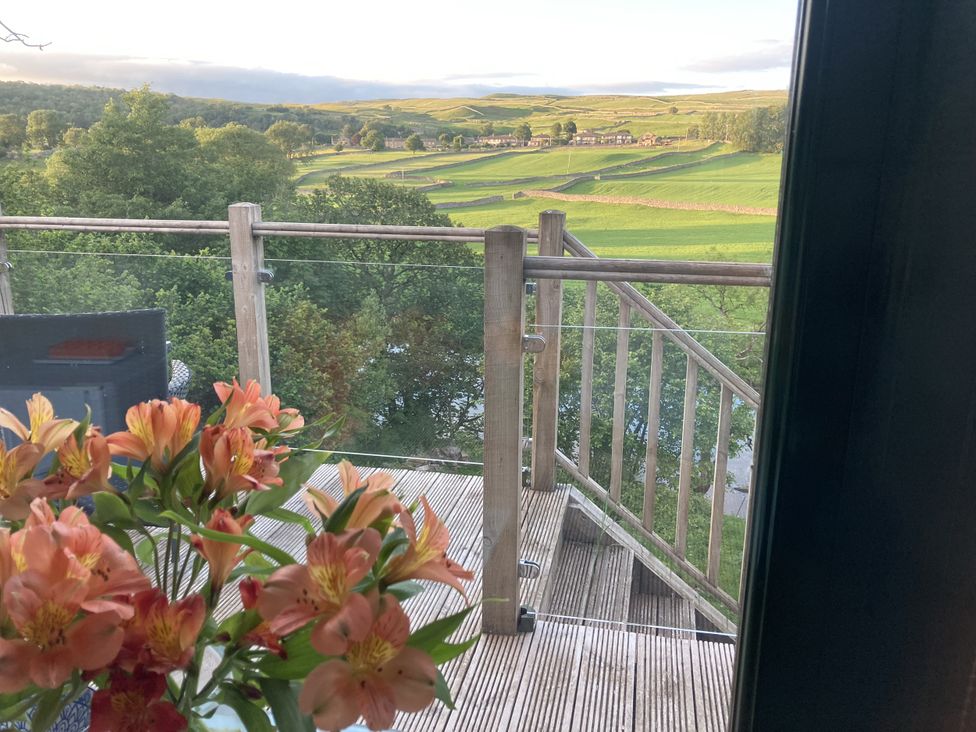 A balcony with flowers and view of landscape at The Sett on the Wharfe Skipton
