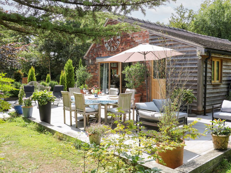 A garden with a table and chairs at Ladycroft Barn Ashbourne