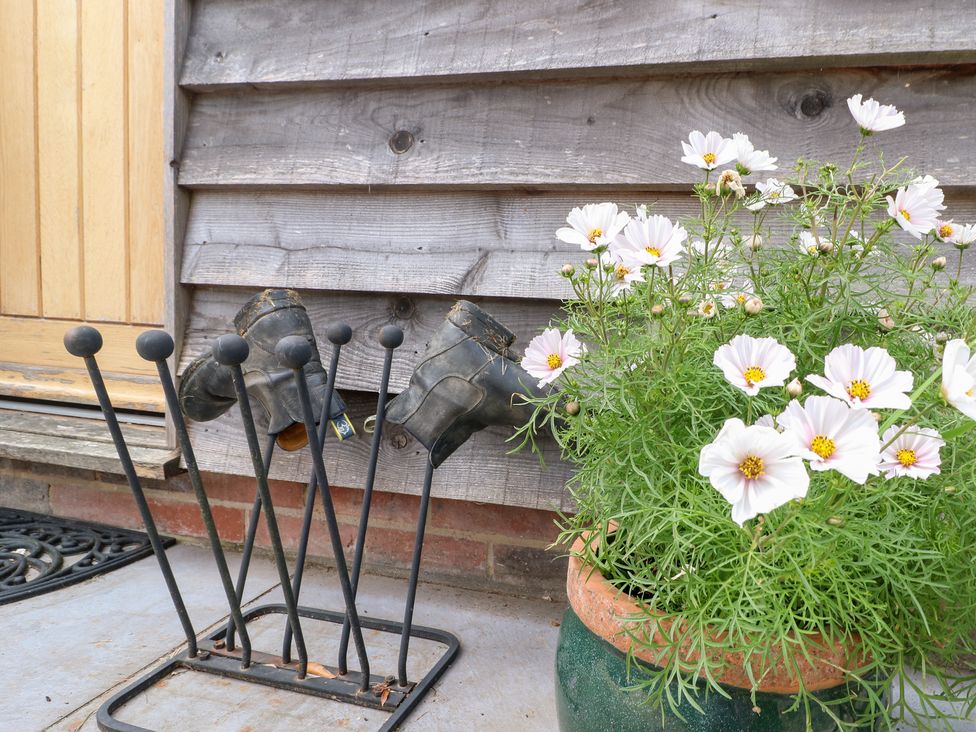 A display of boots and flowers outside at Ladycroft Barn Ashbourne