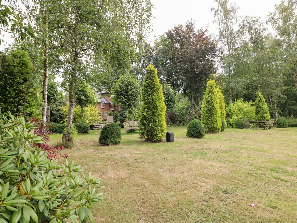 A garden with trees and furniture at Ladycroft Barn Ashbourne
