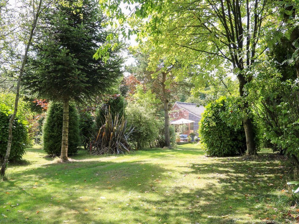 A garden with trees and bushes at Ladycroft Barn Ashbourne