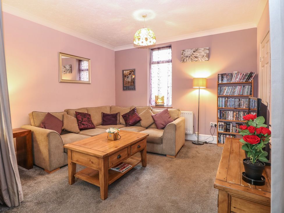 A living room with a sofa and coffee table at 4 Trafalgar Square Great Yarmouth