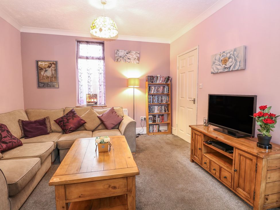 A living room with a sofa and television at 4 Trafalgar Square, Great Yarmouth