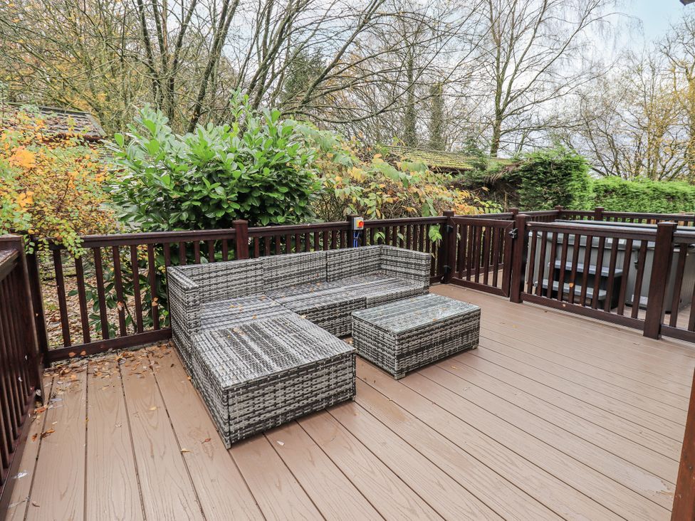 An outdoor area with seating and table at Damson Lodge Thirlmere 8, White Cross Bay, Windermere