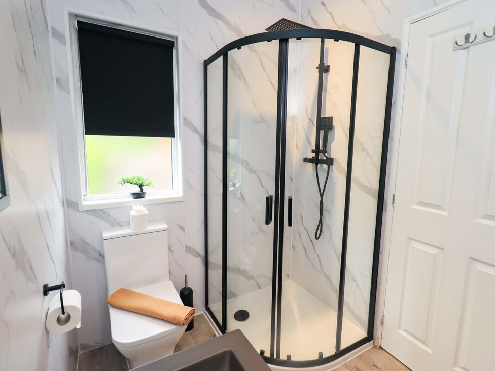 A bathroom with a shower and toilet at Rydal Lodge, Grasmere 24, White Cross Bay near Windermere
