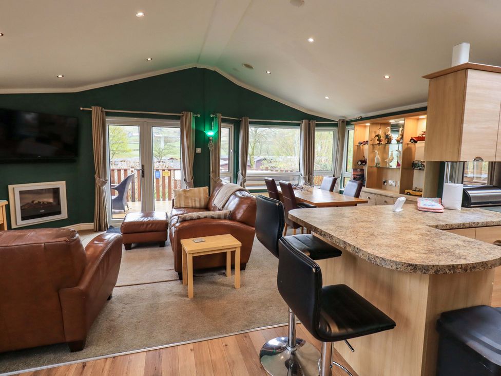 A living room with a sofa and television at Elder Lodge Kirkstone 5 Limefitt Park near Windermere
