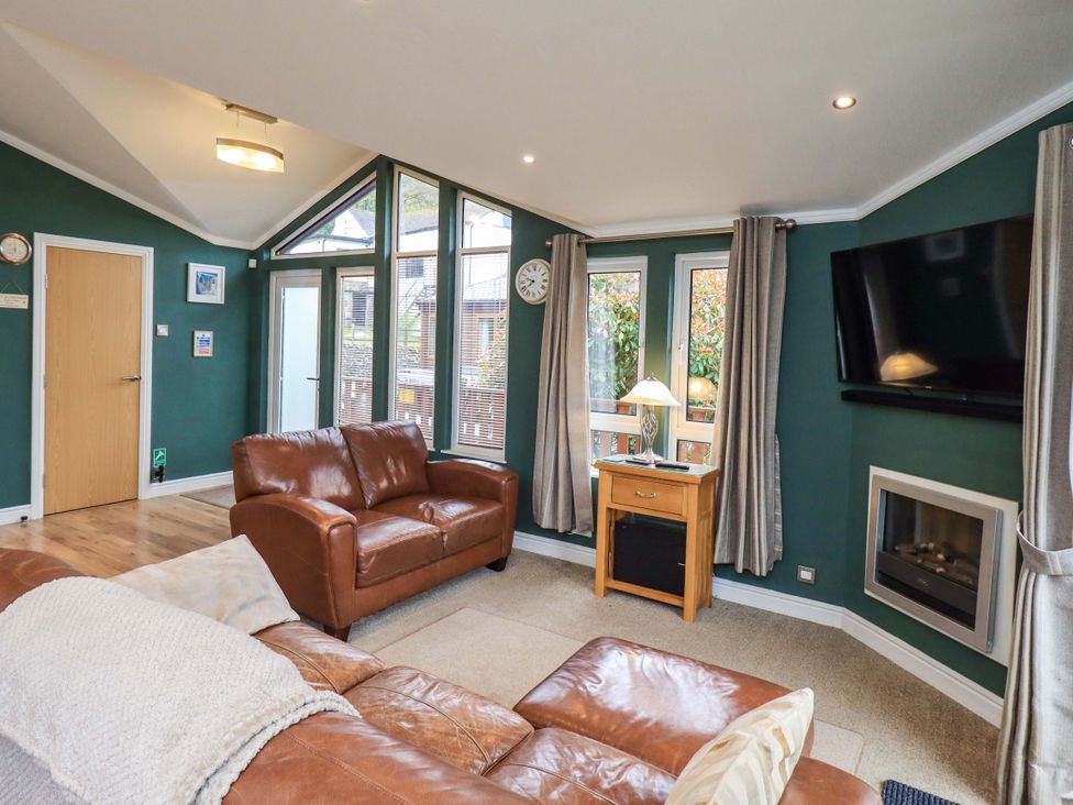 A living room with a sofa and a television at Elder Lodge Kirkstone 5 Limefitt Park near Windermere