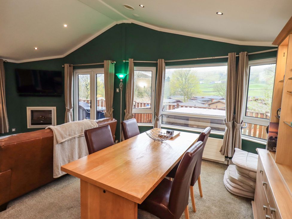 A dining room with a table and chairs at Elder Lodge Kirkstone 5 Limefitt Park near Windermere