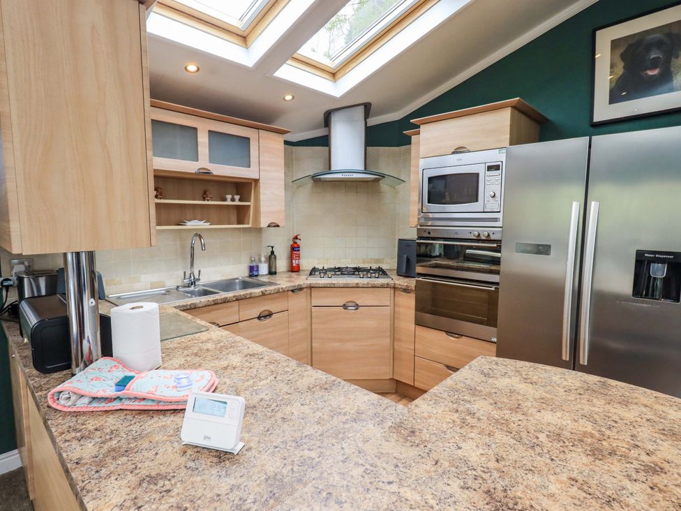 A kitchen with appliances and countertops at Elder Lodge Kirkstone 5 Limefitt Park near Windermere