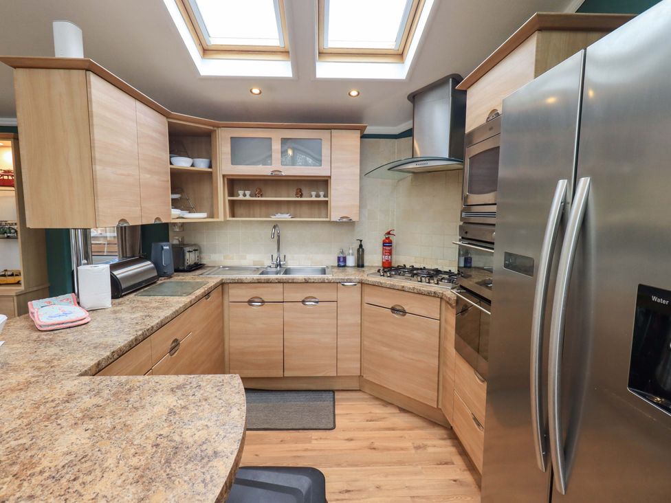 A kitchen with cabinets and appliances at Elder Lodge in Kirkstone 5, Limefitt Park near Windermere