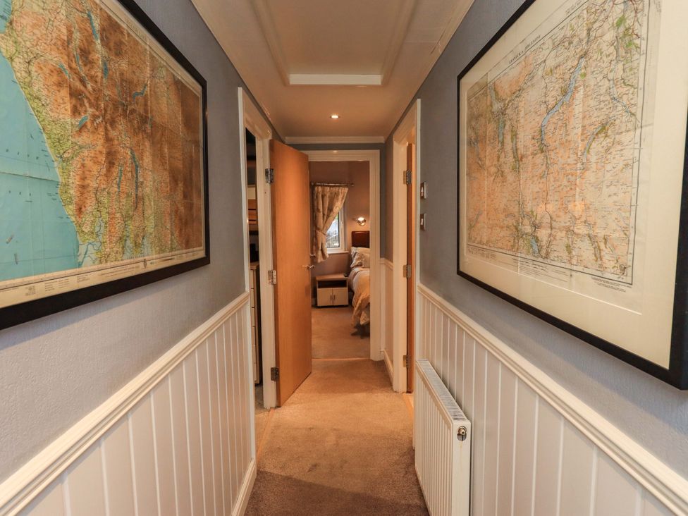 A hallway with maps on the walls at Elder Lodge, Kirkstone 5, Limefitt Park near Windermere
