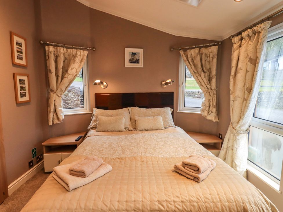 A bedroom with a bed and window at Elder Lodge, Kirkstone 5, Limefitt Park near Windermere