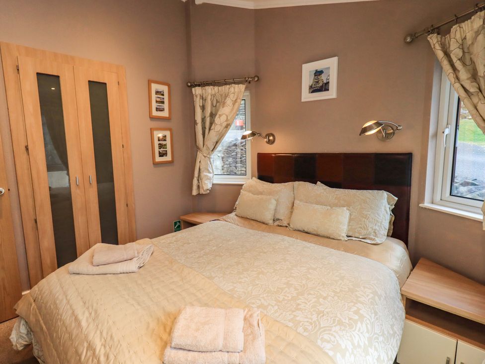 A bedroom with a bed and wardrobe at Elder Lodge near Windermere
