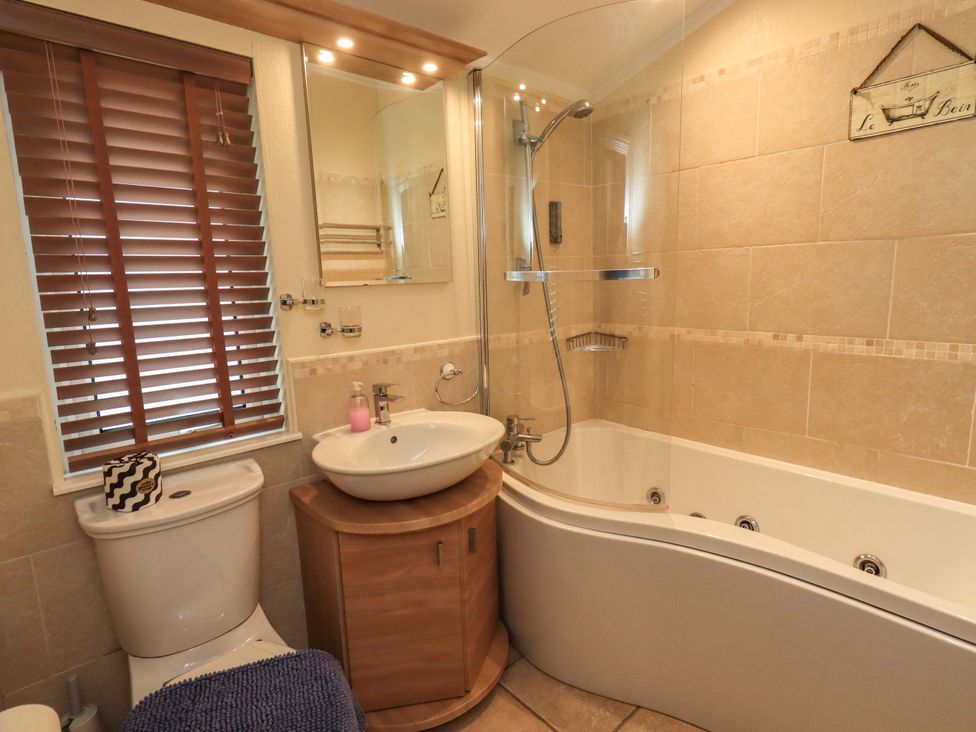 A bathroom with a bathtub, toilet, and sink at Elder Lodge, Kirkstone 5, Limefitt Park near Windermere