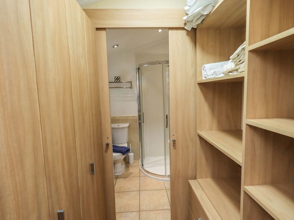A bathroom with a shower, toilet, and sink at Elder Lodge, Kirkstone 5, Limefitt Park near Windermere