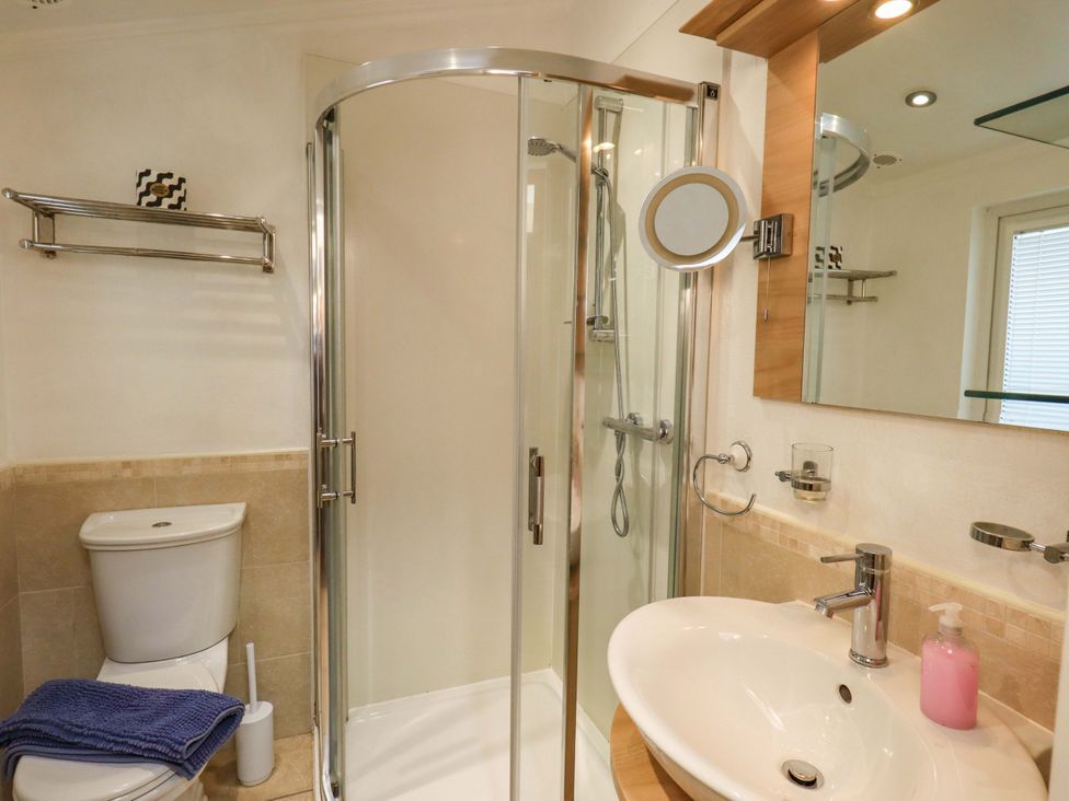 A bathroom with a shower, toilet, and sink at Elder Lodge, Kirkstone 5, Limefitt Park near Windermere