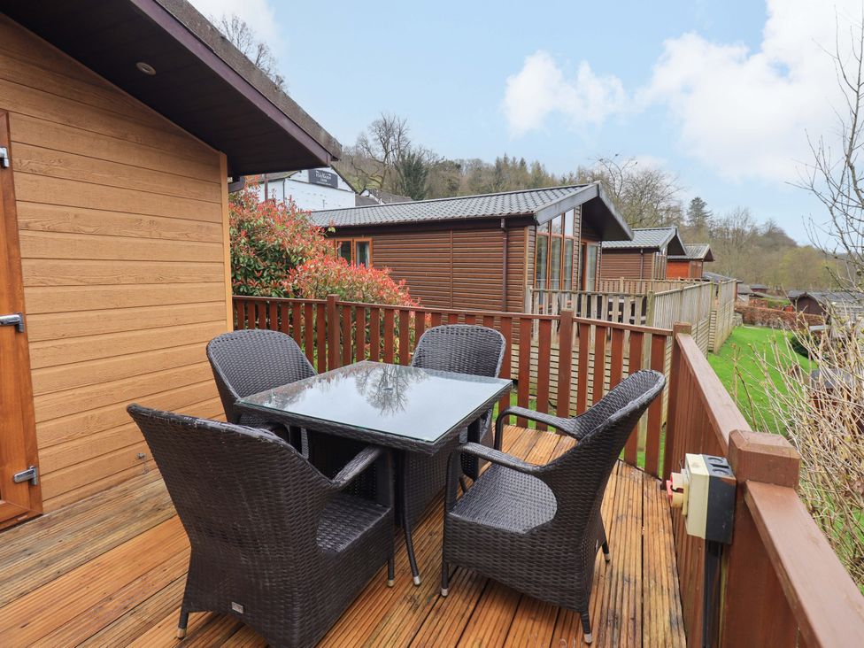 An outdoor seating area with a table and chairs at Elder Lodge Kirkstone 5 Limefitt Park near Windermere