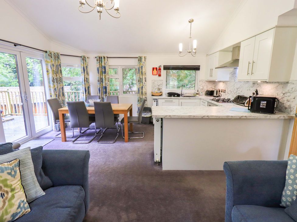 A kitchen with a dining area and seating at Forest Pines Lodge Beech Hill 10 Fallbarrow Park near Bowness on Windermere