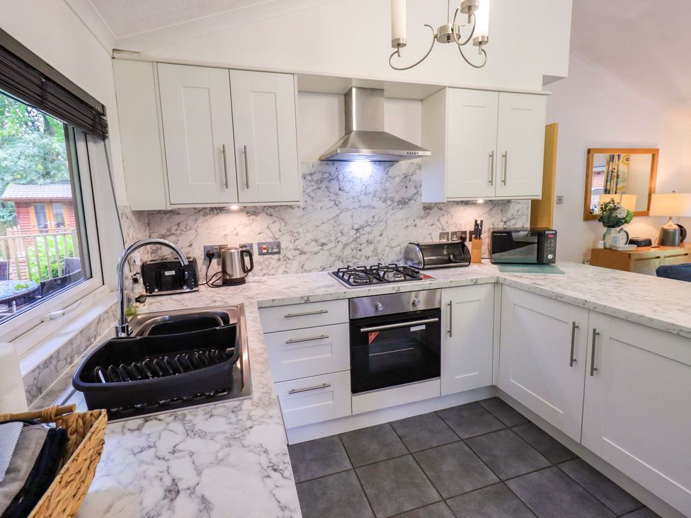 A kitchen with a sink and stove at Forest Pines Lodge Beech Hill 10, Fallbarrow Park near Bowness on Windermere