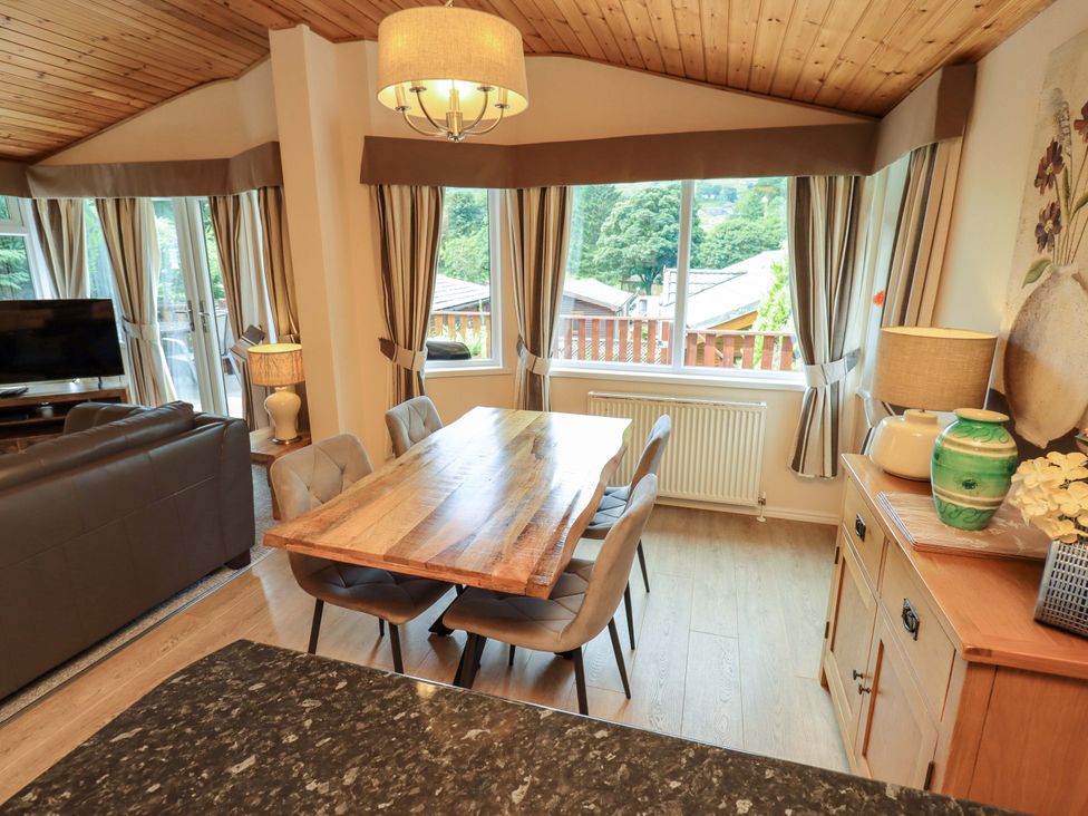 A dining room with a table and chairs at Birthwaite Lodge, Fellside 6, Limefitt Park near Windermere