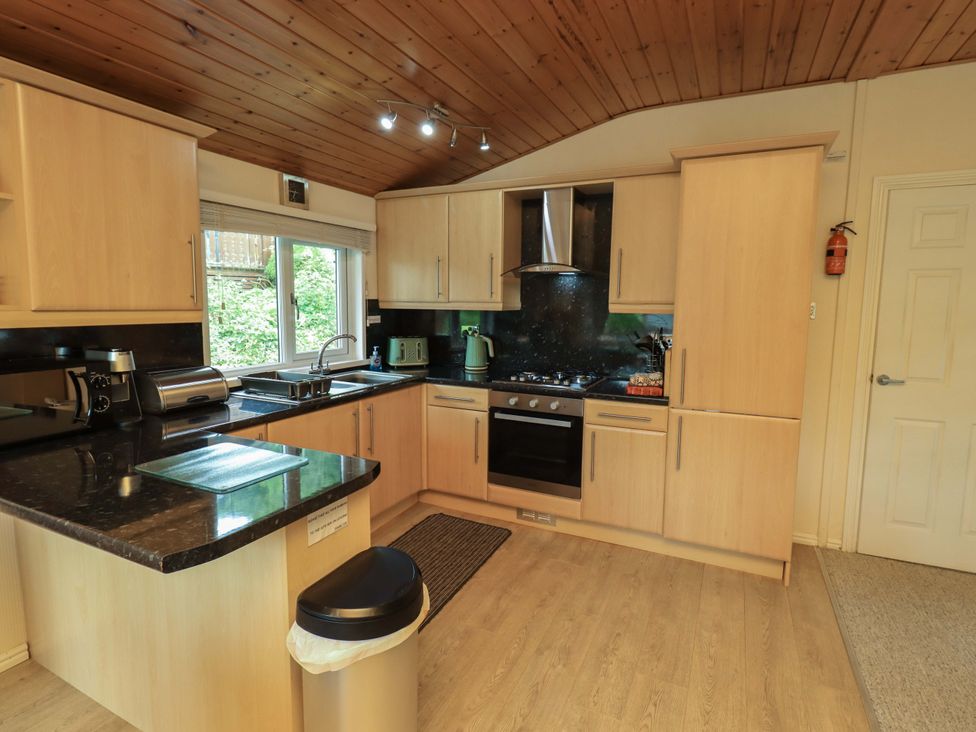 A kitchen with cabinets, sink, and appliances at Birthwaite Lodge, Fellside 6, Limefitt Park near Windermere