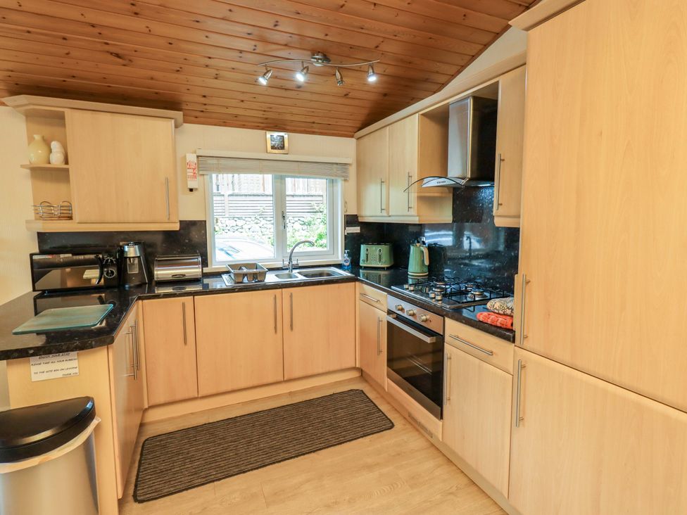 A kitchen with a sink and stove at Birthwaite Lodge Fellside 6 Limefitt Park near Windermere