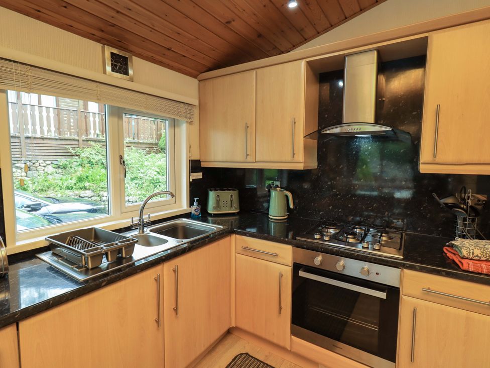 A kitchen with appliances and utensils at Birthwaite Lodge Fellside 6, Limefitt Park near Windermere