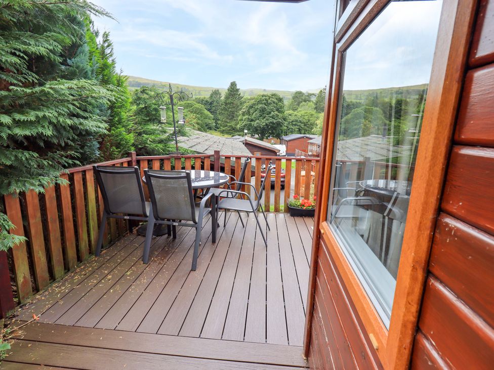 An outdoor deck with a table and chairs at Birthwaite Lodge near Fellside 6, Limefitt Park near Windermere