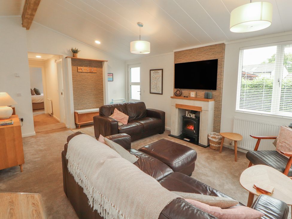 A living room with a sofa and television at Beech Grove Lodge Glade 17, Fallbarrow Park near Bowness on Windermere