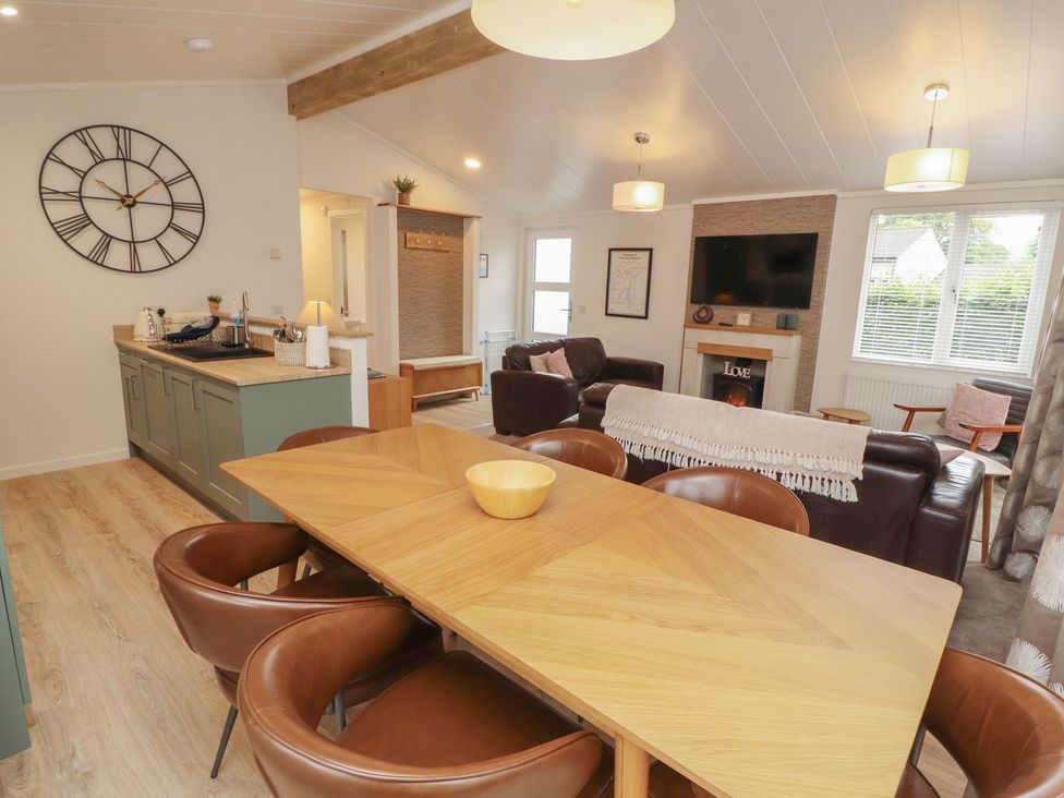 A dining room with a table and chairs at Beech Grove Lodge in Glade 17, Fallbarrow Park near Bowness on Windermere