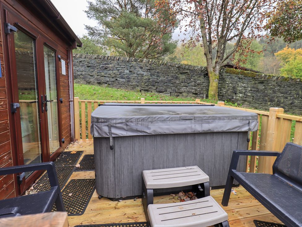 An outdoor space with a hot tub and seating at Robin View Lodge Beckside 3 Limefitt Park near Windermere
