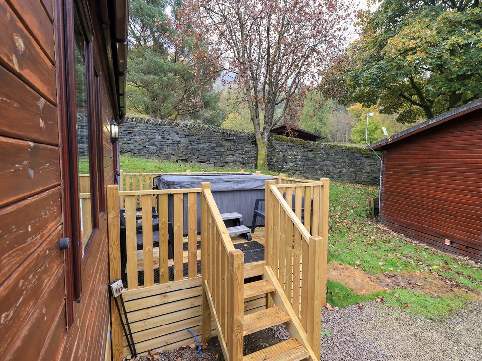 An outdoor area with a deck and hot tub at Robin View Lodge, Beckside 3, Limefitt Park near Windermere