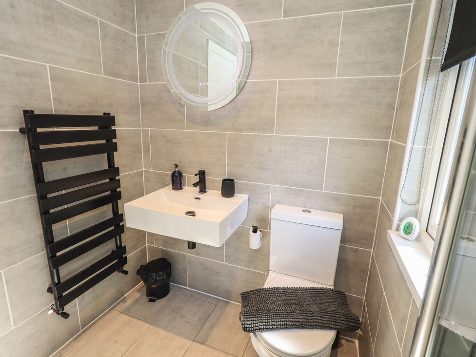 A bathroom with a sink and toilet at Badgers Hollow Lodge Grasmere 30, White Cross Bay near Windermere