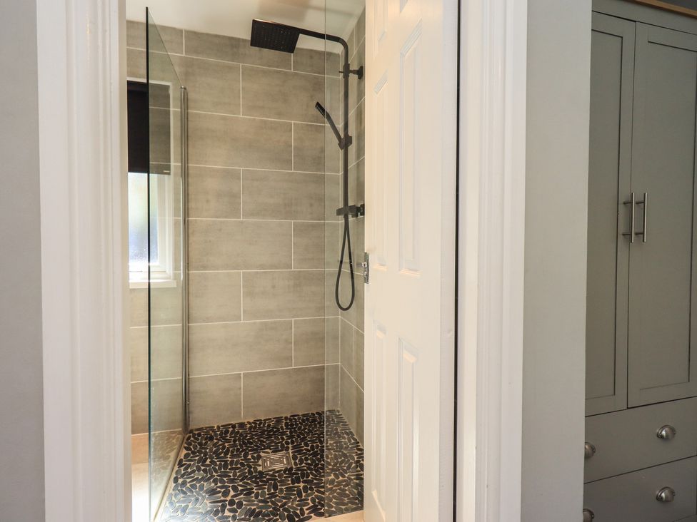 A shower area with a glass enclosure at Badgers Hollow Lodge in Grasmere 30, White Cross Bay near Windermere