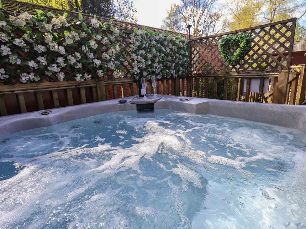 A hot tub with water and bubbles at Badgers Hollow Lodge in Grasmere 30, White Cross Bay near Windermere