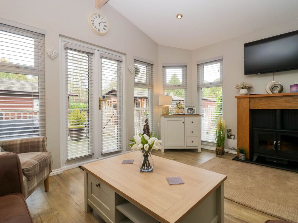 A living room with a coffee table and sofa at Badgers Hollow Lodge Grasmere 30, White Cross Bay near Windermere