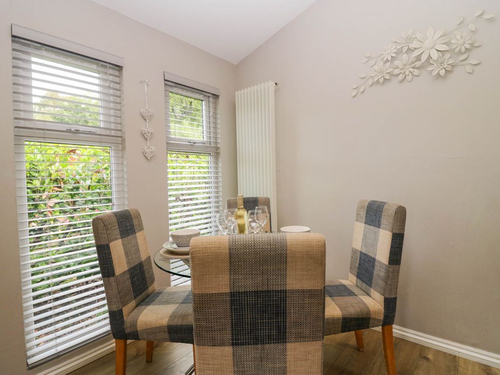 A dining room with a table and chairs at Badgers Hollow Lodge Grasmere 30 White Cross Bay near Windermere