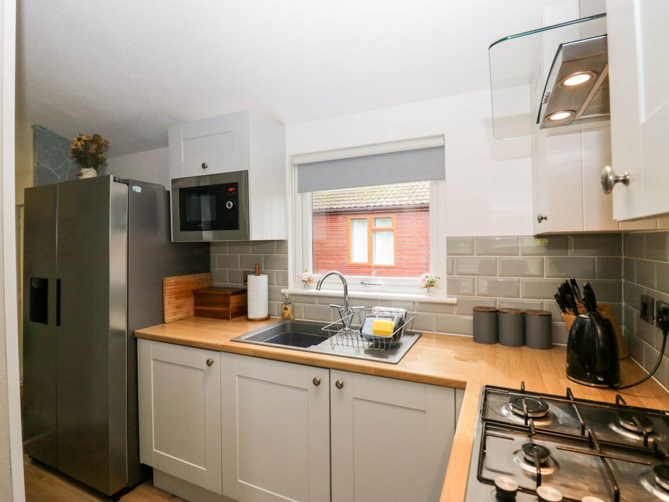 A kitchen with appliances and counter space at Badgers Hollow Lodge Grasmere 30, White Cross Bay near Windermere