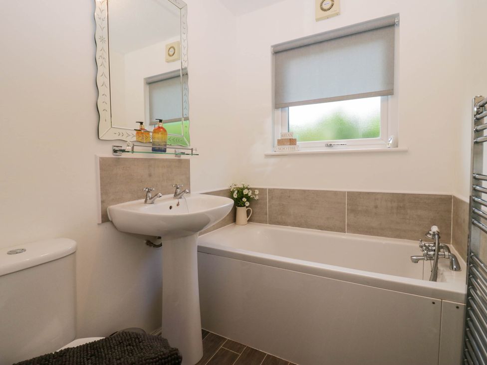 A bathroom with a sink, bathtub and toilet at Badgers Hollow Lodge Grasmere 30, White Cross Bay near Windermere