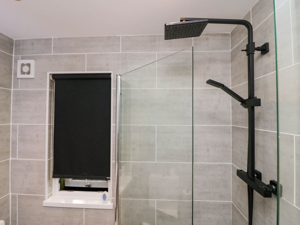 A bathroom with a shower and a window at Badgers Hollow Lodge in Grasmere 30, White Cross Bay near Windermere
