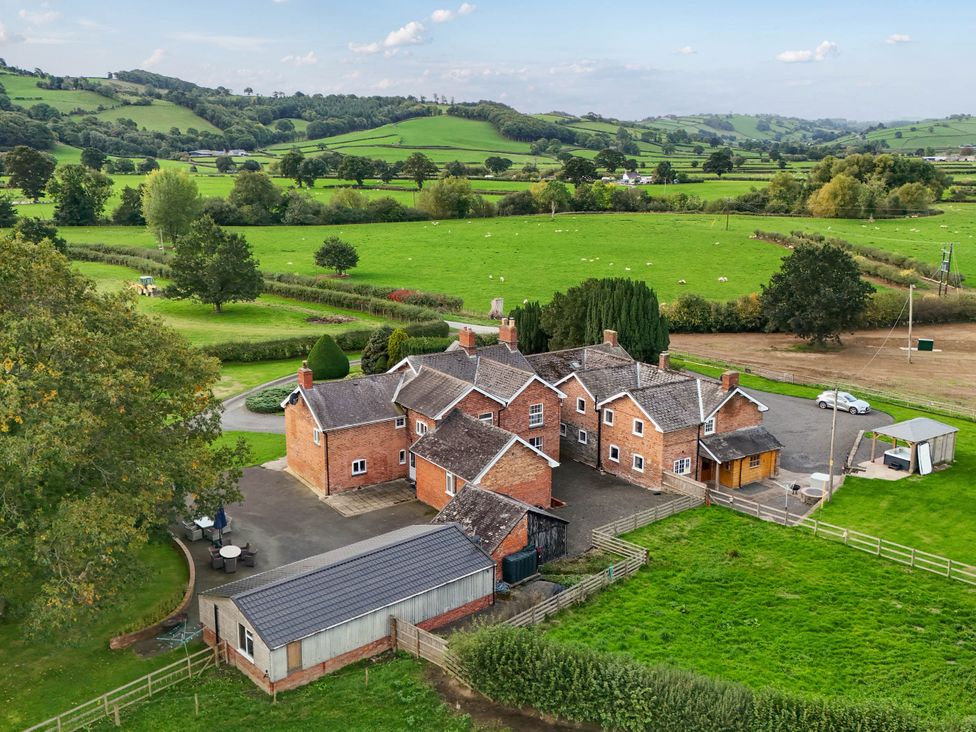 A house and garden with a vehicle and landscape at Bodaioch Hall Trefeglwys near Caersws