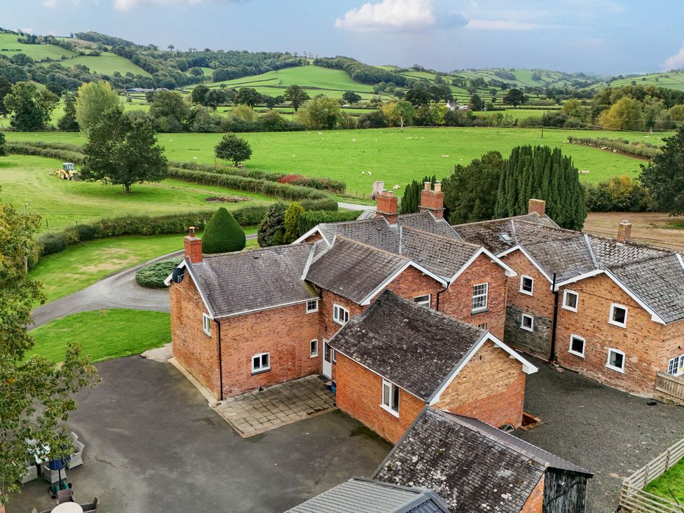 An outdoor view of houses and fields at Bodaioch Hall near Trefeglwys Caersws