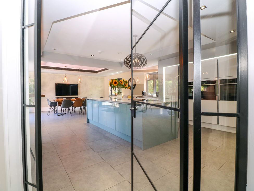 A kitchen with an island and dining area at Thornbury in Barnard's Green, Malvern