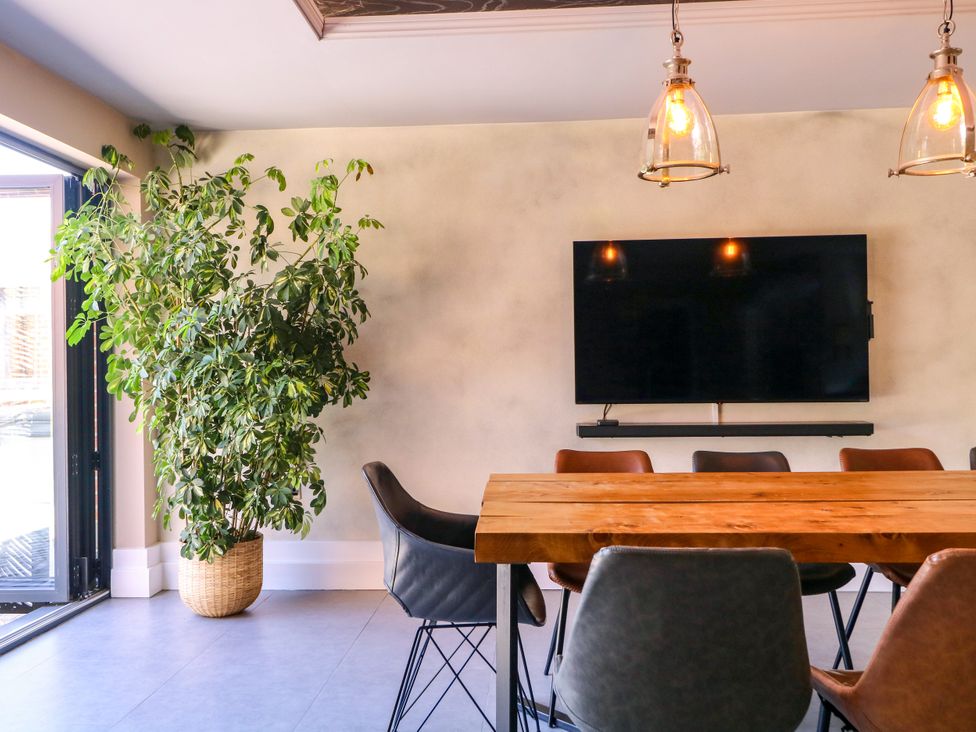 A dining room with a table and chairs at Thornbury, Barnard's Green, Malvern