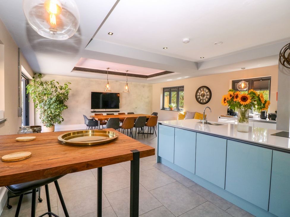 A kitchen with a dining table and chairs at Thornbury, Barnard's Green, Malvern
