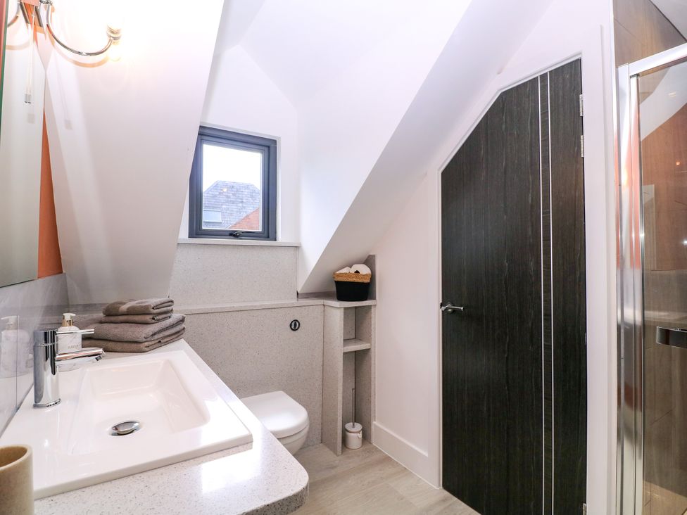 A bathroom with a sink and shower at Thornbury in Barnard's Green, Malvern
