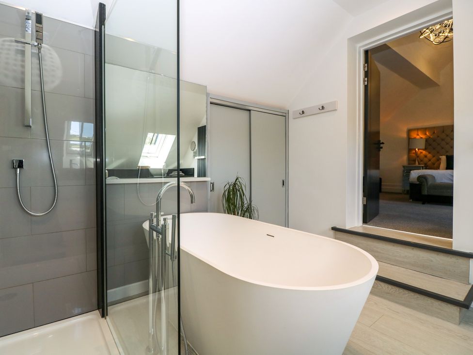 A bathroom with a bathtub and shower at Thornbury, Barnard's Green, Malvern