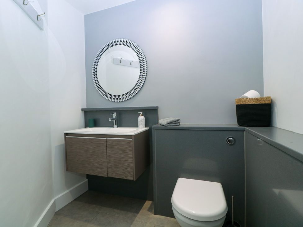 A bathroom with a sink and mirror at Thornbury in Barnard's Green, Malvern