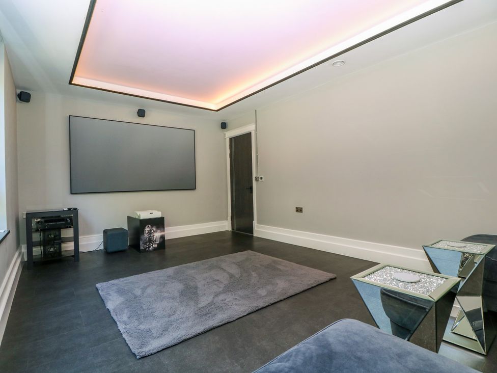 A living room with a television and sound system at Thornbury, Barnard's Green, Malvern